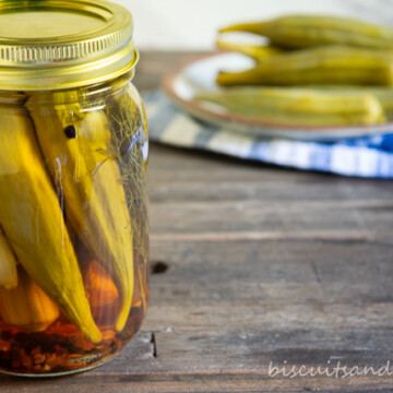pickled okra in jar with a few on plate behind
