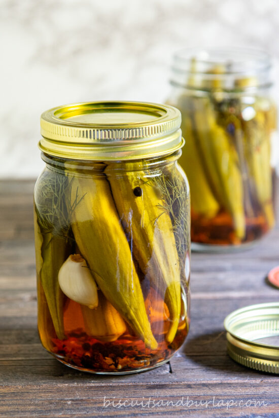 jar of pickled okra with another jar behind