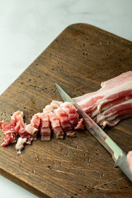bacon being cut with knife