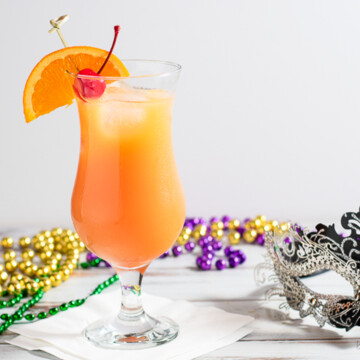 hurricane cocktail with mardis gras beads.