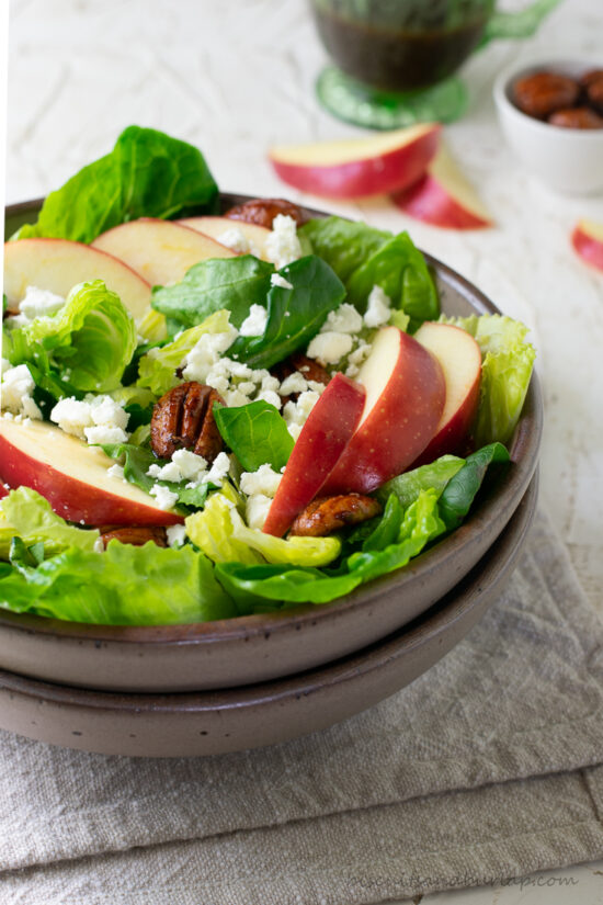 apple cider vinaigrette in pitcher behind fall salad