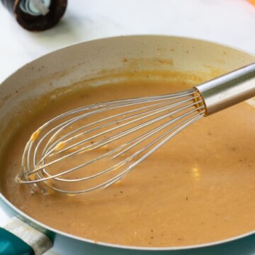 gravy in skillet with whisk