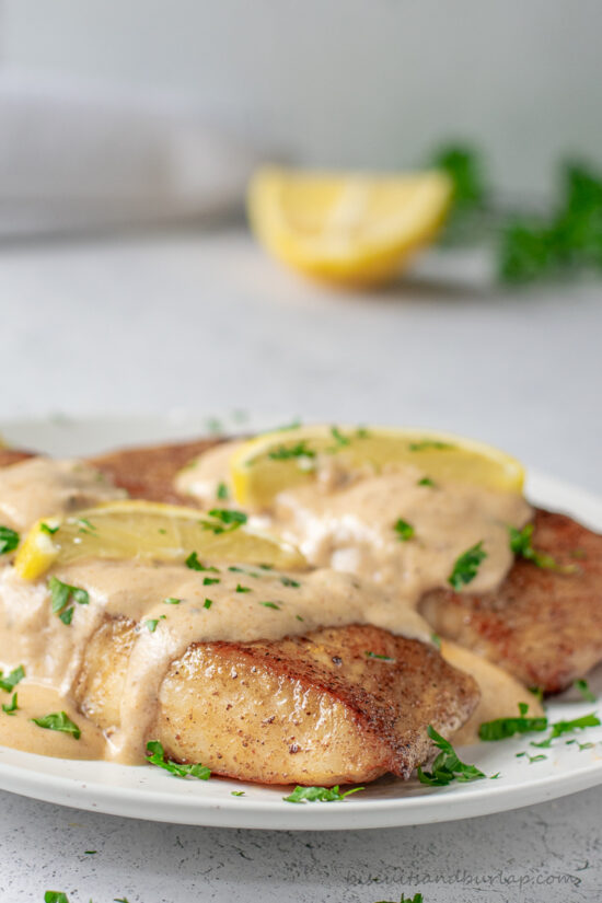 two fish filets with cajun cream sauce