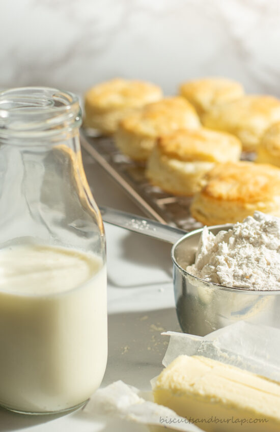 buttermilk biscuits in background with ingredients in front