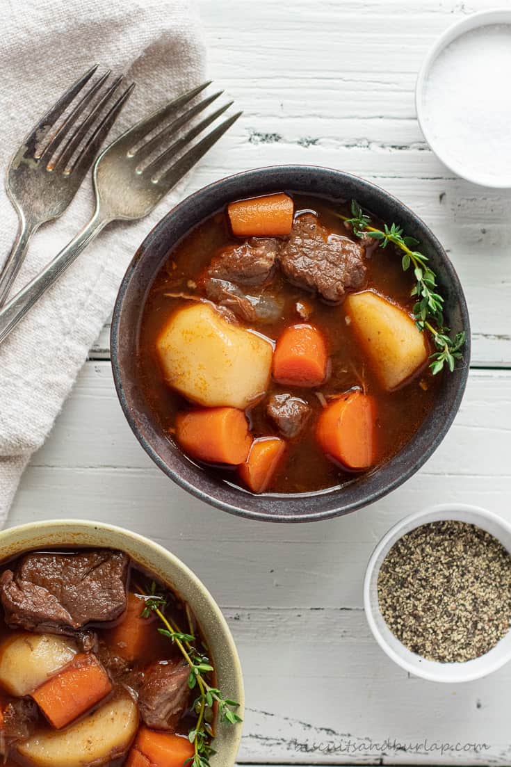 Two bowls of Guinness Beef Stew on a white table.