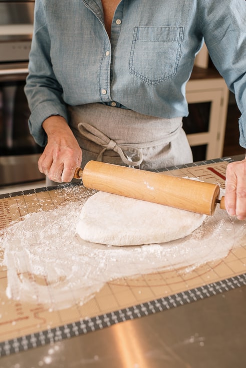 woman rolling biscuit dough