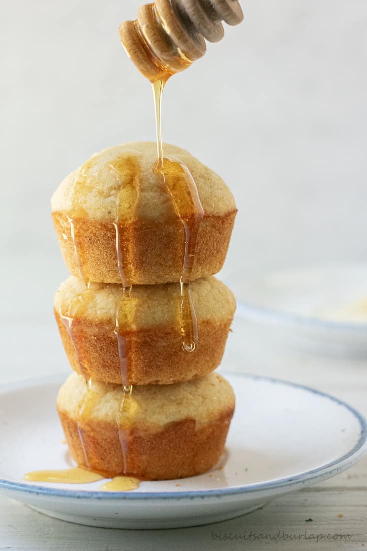 stack of 3 buttermilk cornbread muffins with honey drizzle