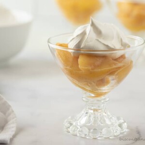 bowl of caramelized peaches wth whipped cream