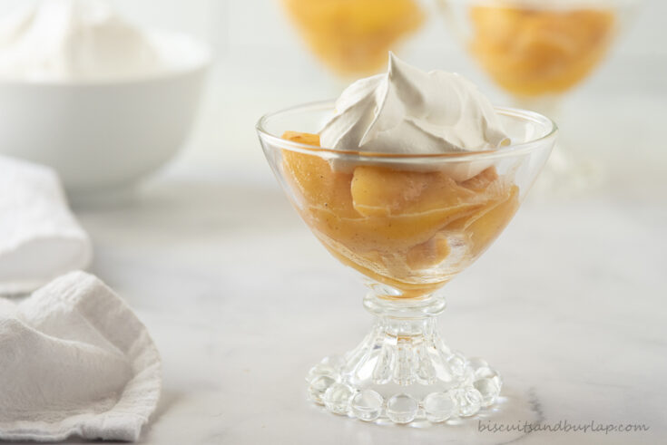 bowl of caramelized peaches wth whipped cream