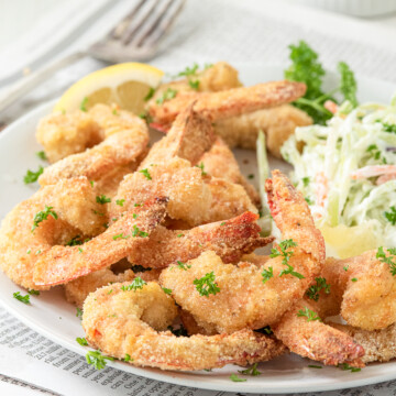 air fryer shrimp on plate with coleslaw.