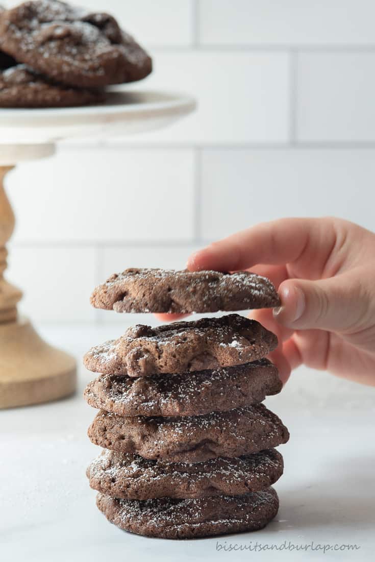 child's hand reaching for double chocolate chip cookie