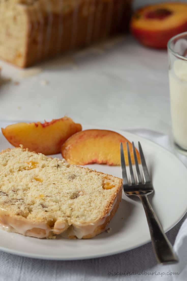 slice of peach bread with peaches and milk