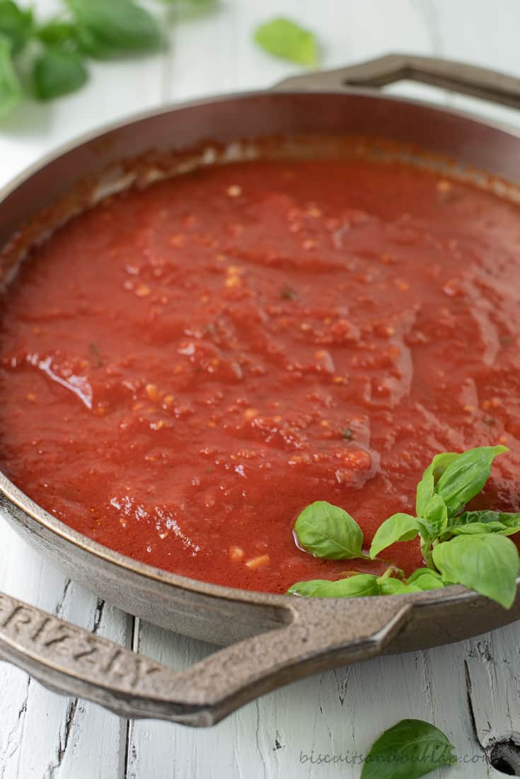 pan of san marzano sauce with basil