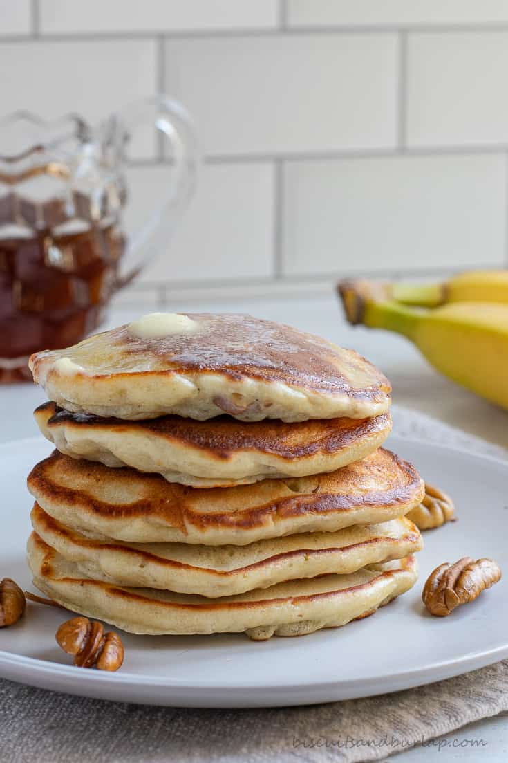 stack of banana pancakes with pecans