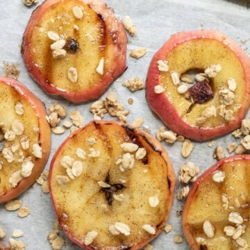 rows of grilled apples with granola and cinnamon sticks