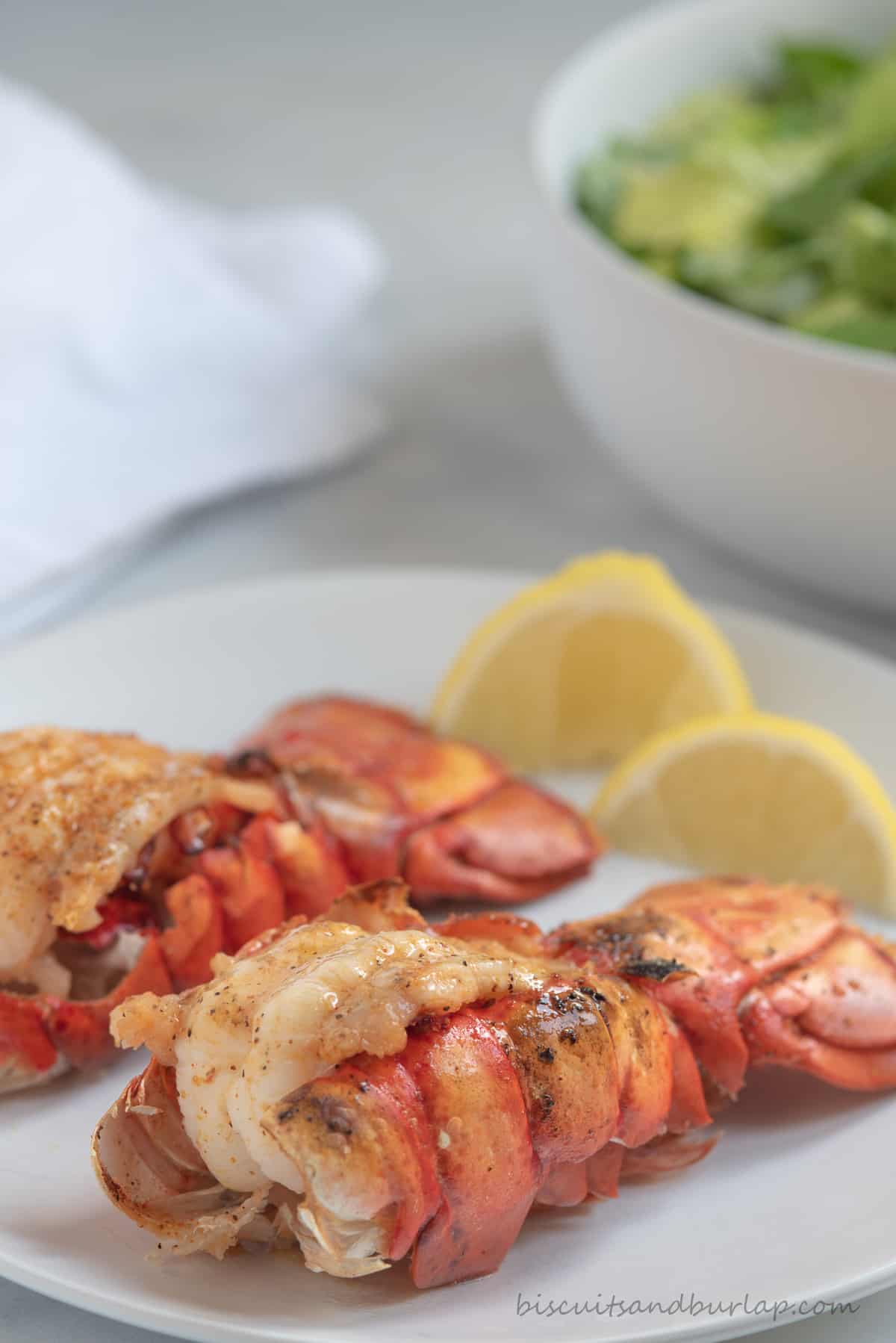 two air fryer lobster tails with lemon