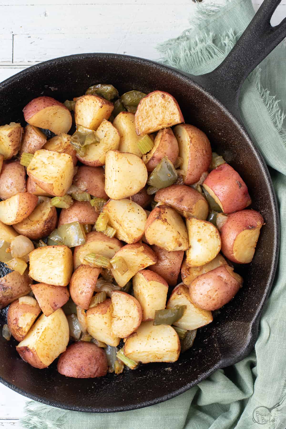 cast iron skillet with cajun spiced potatoes