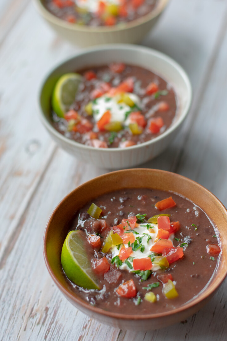 three bowls of black bean and ham soup