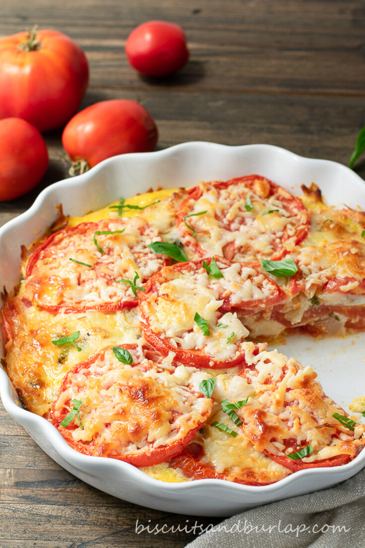 low carb tomato pie with slice out and tomatoes behind