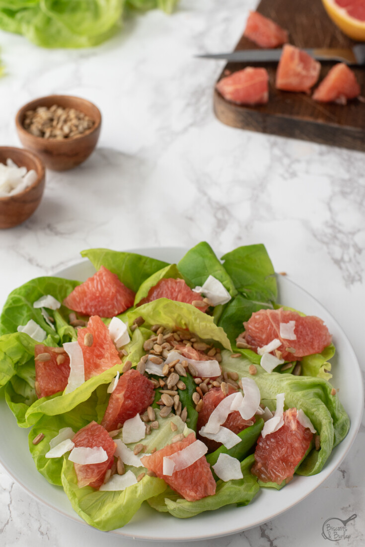 salad with grapefruit on plate and ingredients behind