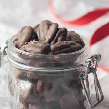 jar of chocolate dipped nuts with red ribbon