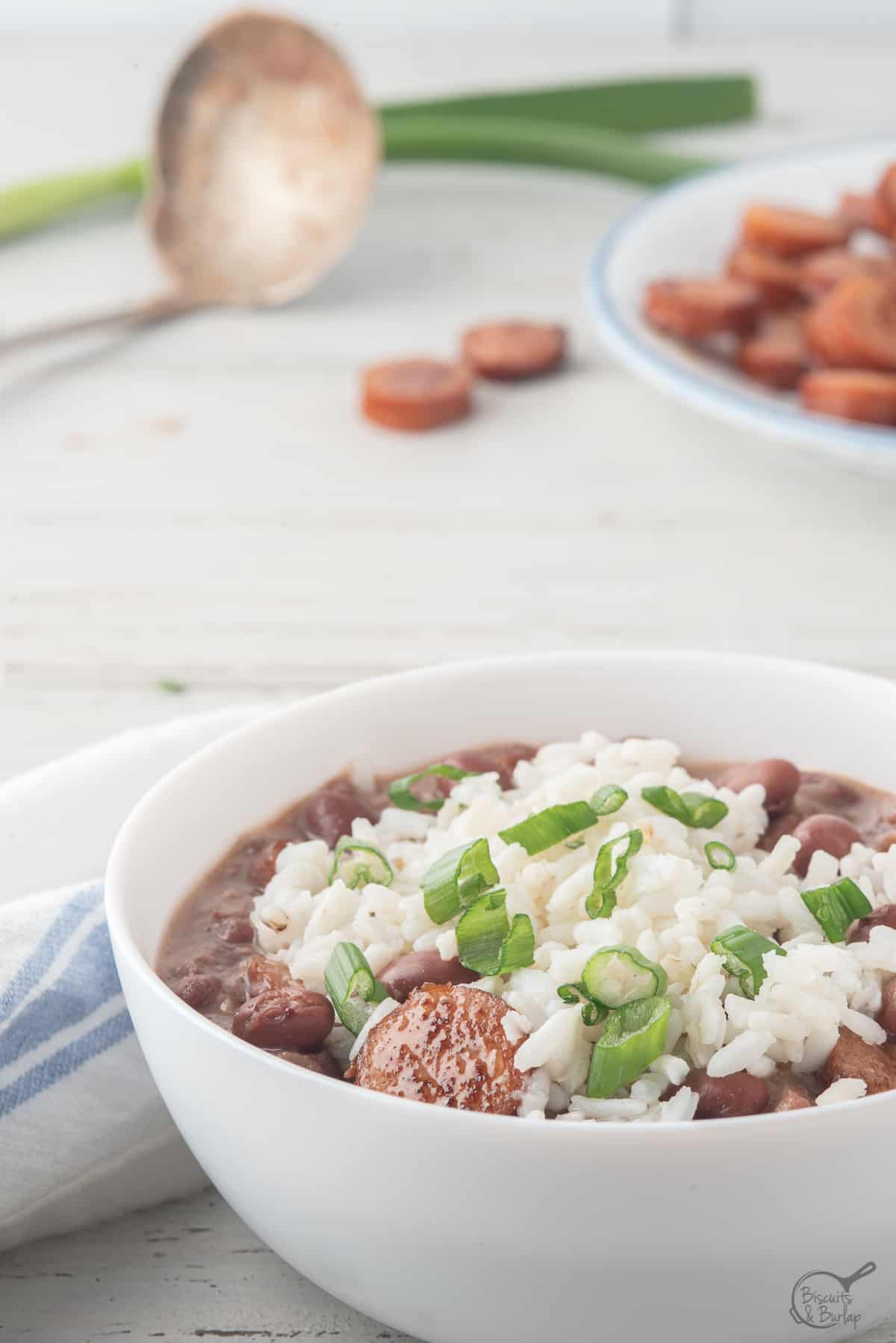 white bowl with andouille sausage, rice and beans.