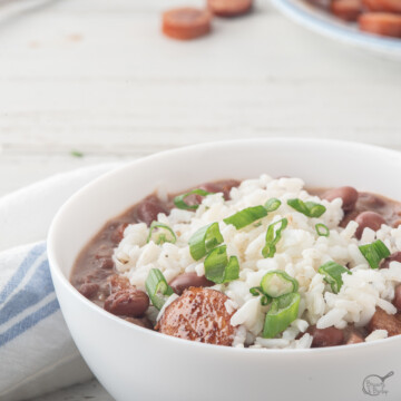 square image of rice, beans and sausage.