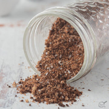 square image of coffee rub spilling out of jar.
