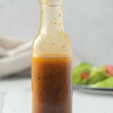 bottle of southwest salad dressing in front of salad.