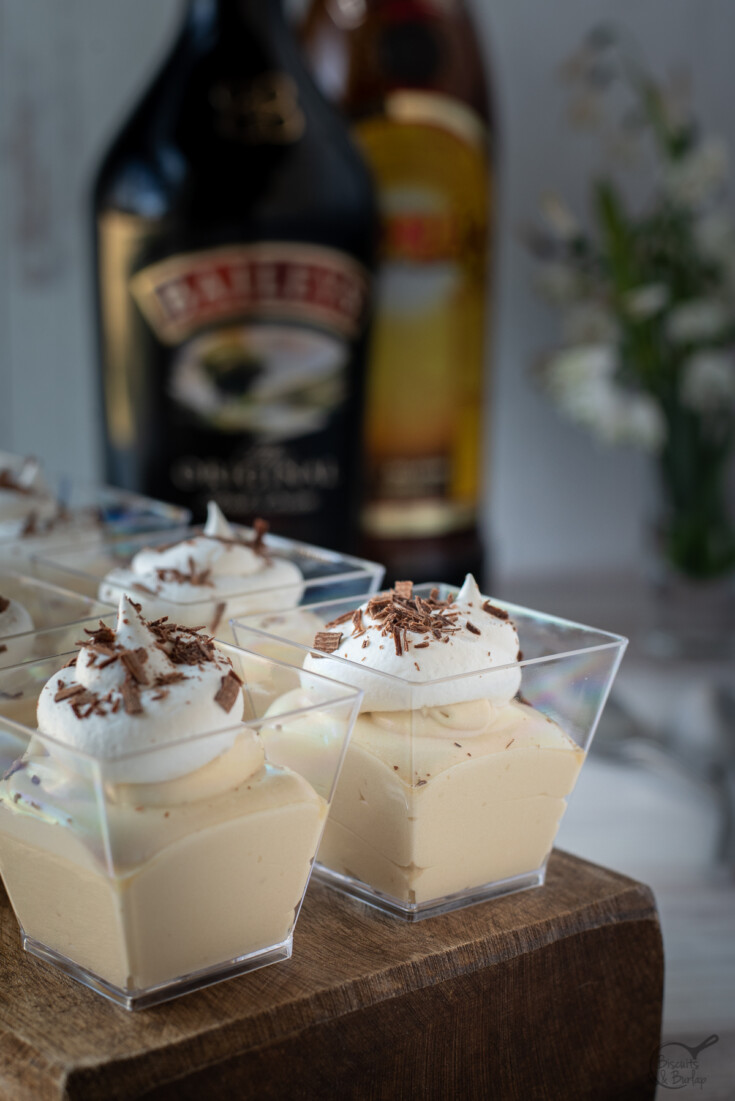Mudslide Pudding Shots in square glass with Bailey's and Kahlua in background.