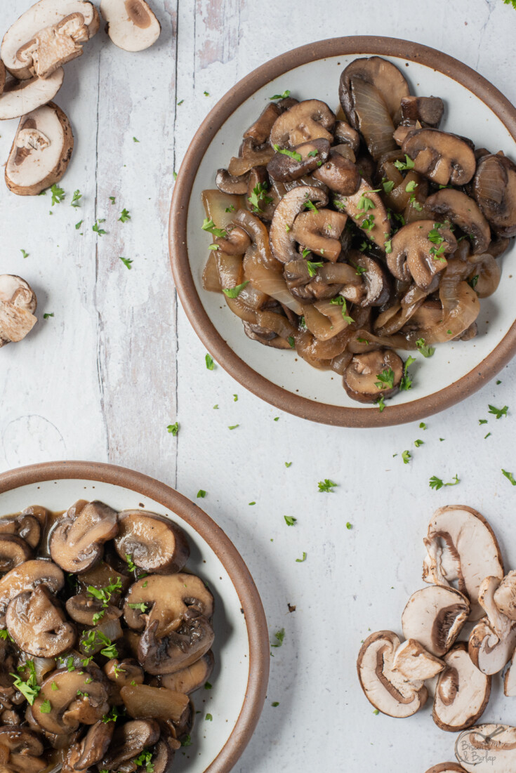 sauteed onions and mushrooms for steak in two small plates