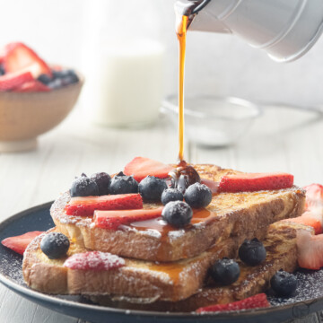 french toast made with sourdough bread and blueberries and strawberries.