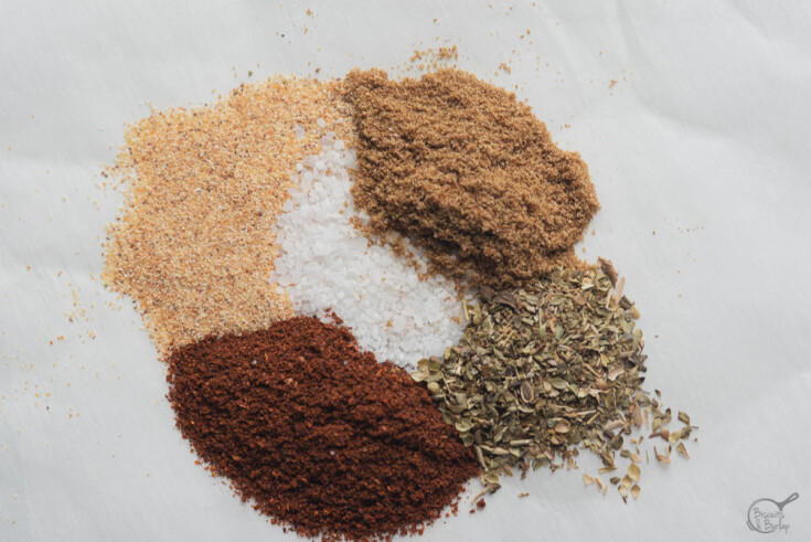 seasonings and spices poured onto parchment paper