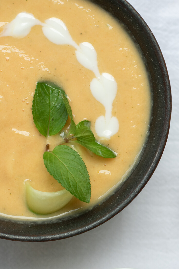 part of a bowl of cold peach soup with heart shaped yogurt drops