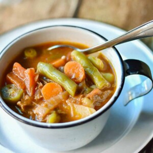square image of southern style vegetable soup in cup