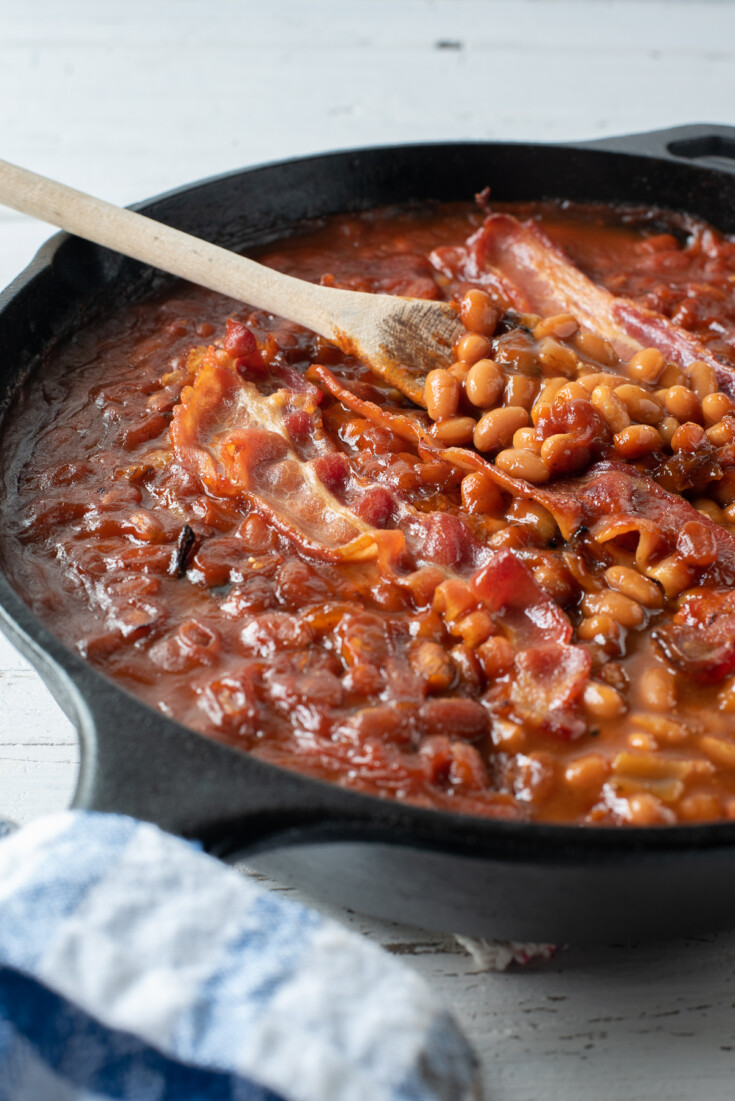 cast iron skillet of smoked baked beans