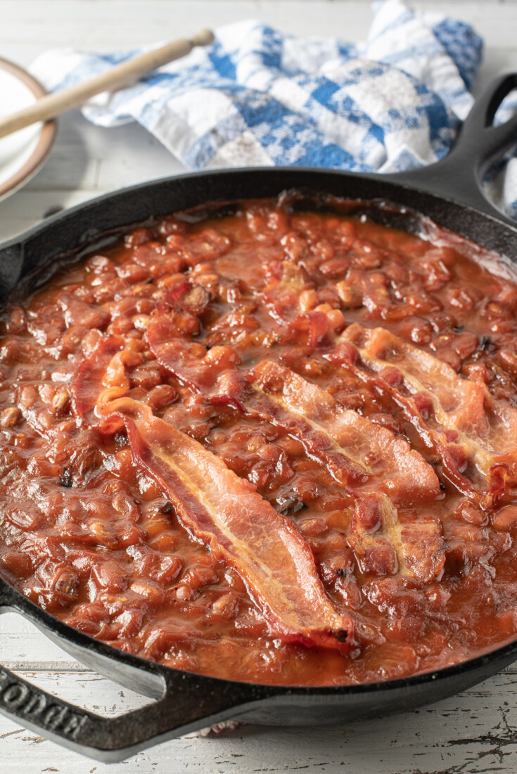 baked beans in skillet that have been cooked on a smoker.