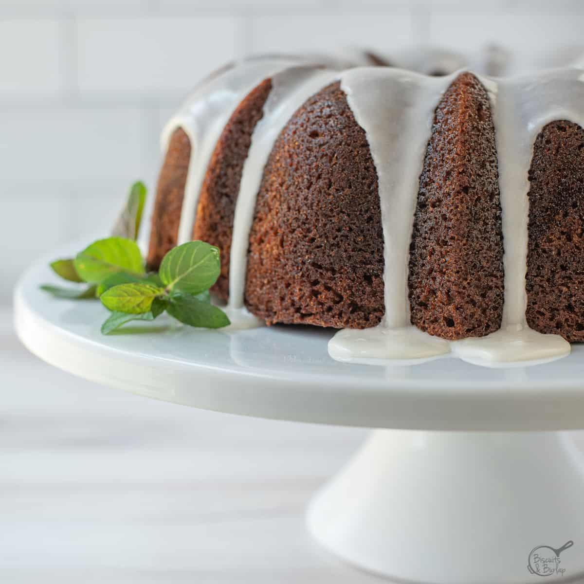 part of a bundt cake with banana on white stand.