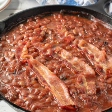 baked beans in skillet that have been cooked on a smoker.