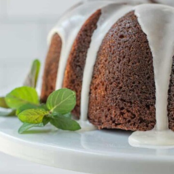 part of a bundt cake with banana on white stand.