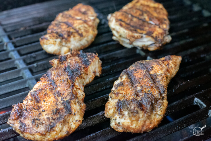 blackened chicken cooking on the grill.