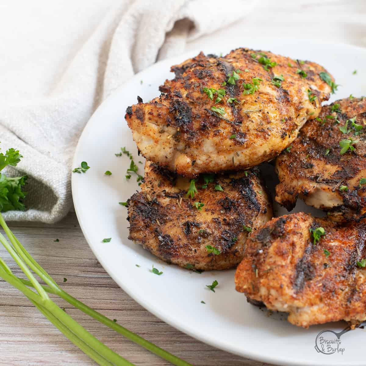 blackened chicken on white plate.