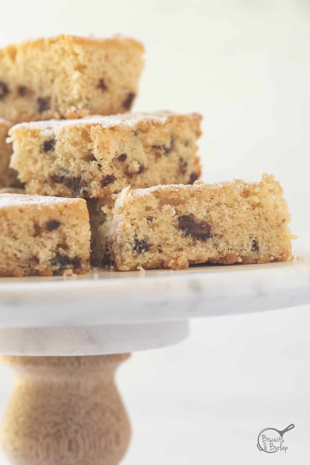 close up of buttermilk bars on cake stand