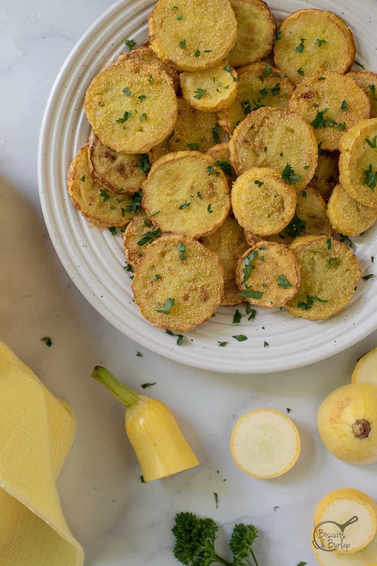 plate of fried squash with some raw squash alongside.