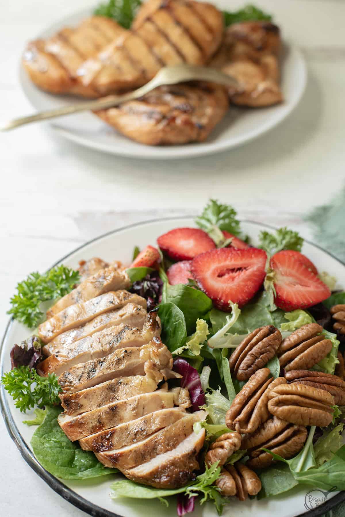 salad with grilled chicken and more behind.