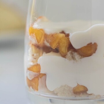 close up of mini peach trifle in glass.