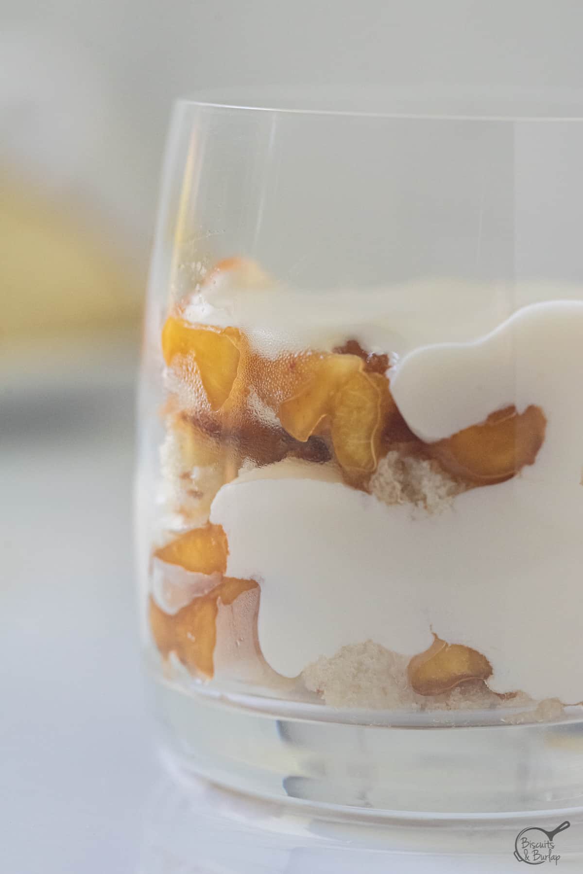 close up of mini peach trifle in glass.