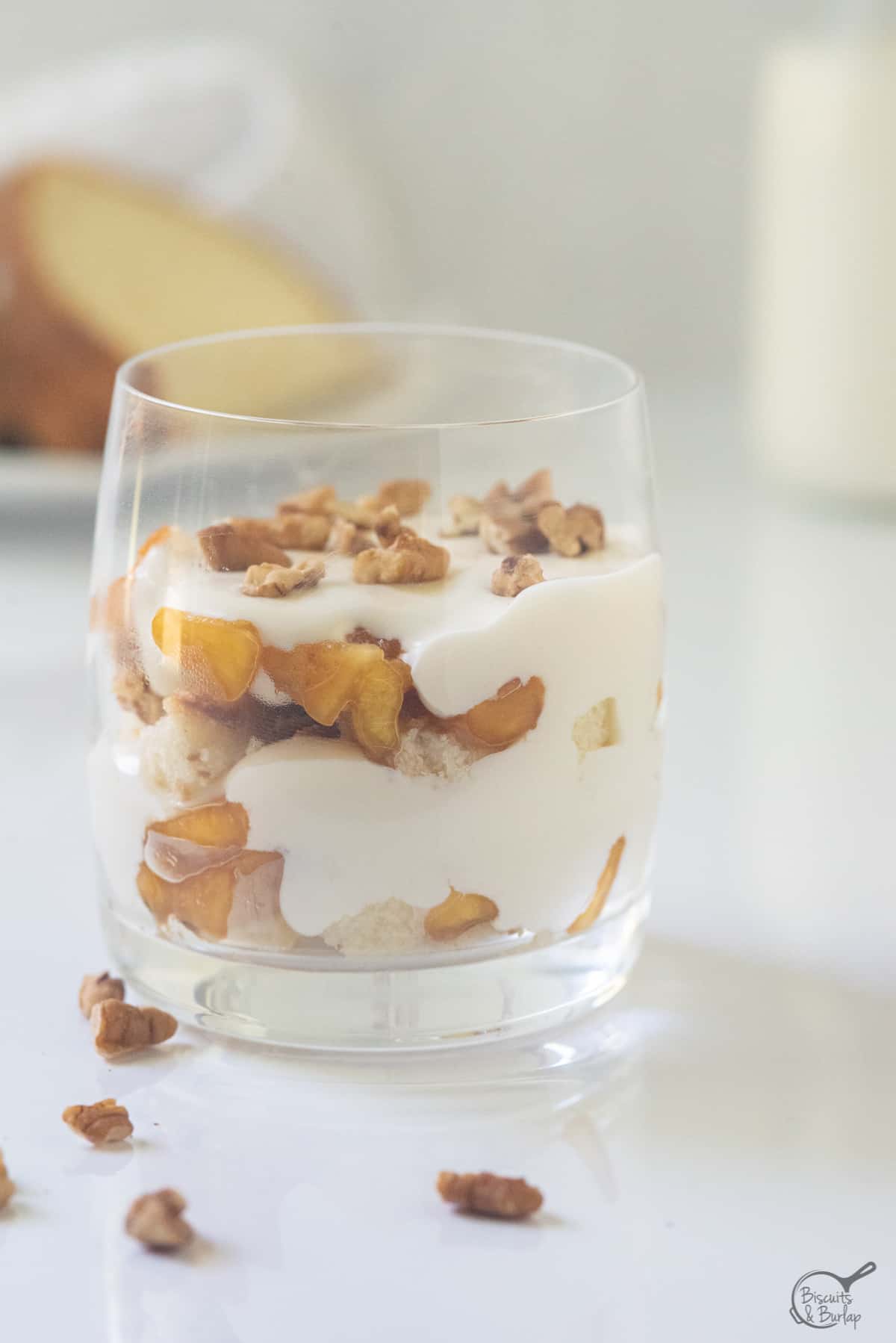 mini size peach trifle with pecans on top and scattered around. 
