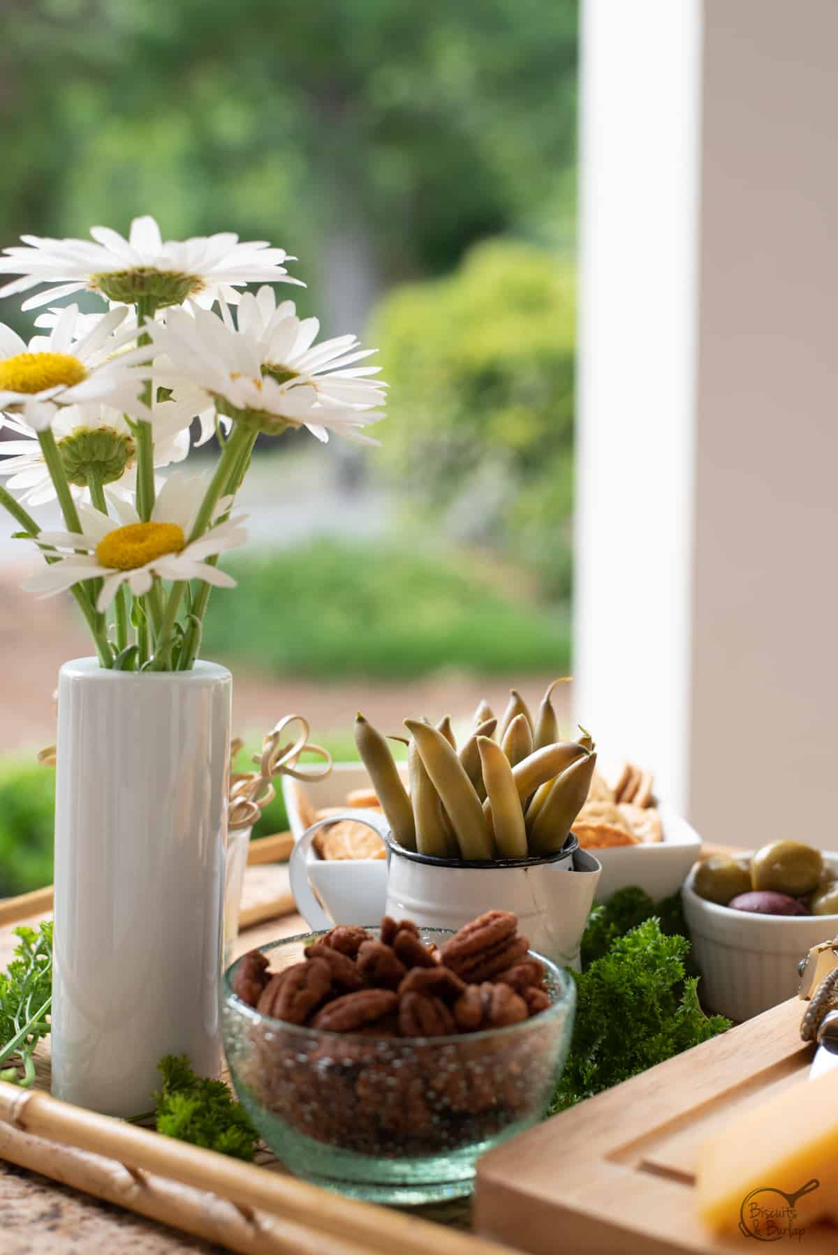 appetizer board with pickled green beans and flowers.