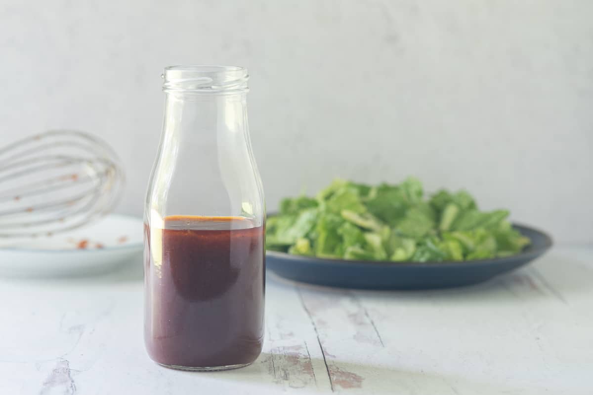 Barbecue Salad Dressing in small milk bottle, salad in background